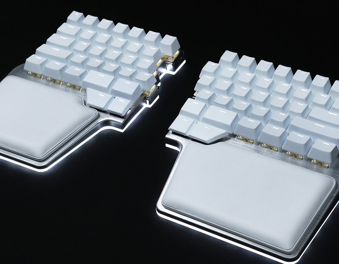 image of the silver Raise 2 split with white keycaps and palm pads