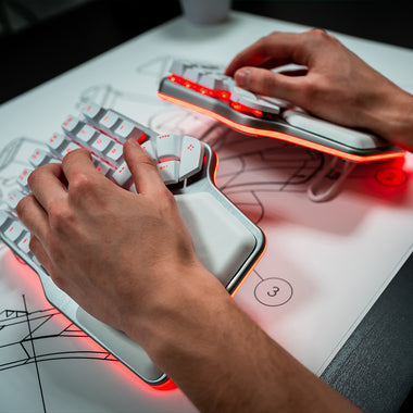 Dygma Defy, white, tented with hands on keyboard